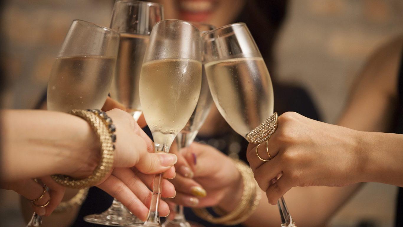 Business women toast with a glass of wine in hand.