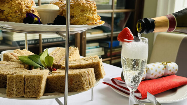 Afternoon tea at The Clarendon with scones, sandwiches, and sparkling wine in a cosy, elegant setting. Perfect for relaxation.