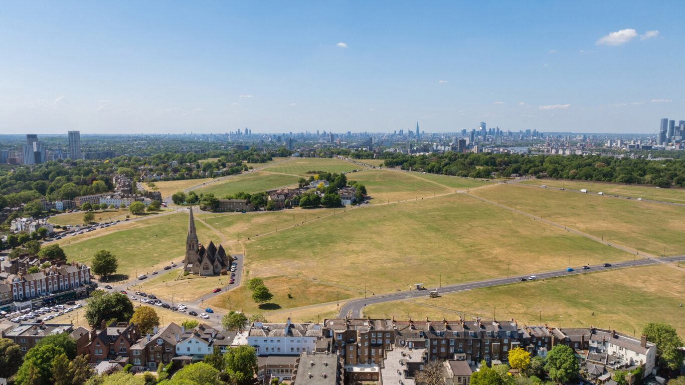 Panoramic view of lush parkland and London skyline near The Clarendon, offering scenic beauty and tranquillity. Ideal for city explorers.