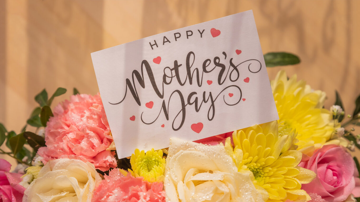 Mother's Day card in a vibrant bouquet of pink, yellow, and white flowers at The Clarendon Hotel; perfect for special stays.
