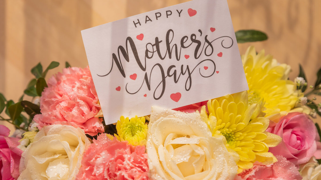 Mother's Day card in a vibrant bouquet of pink, yellow, and white flowers at The Clarendon Hotel; perfect for special stays.