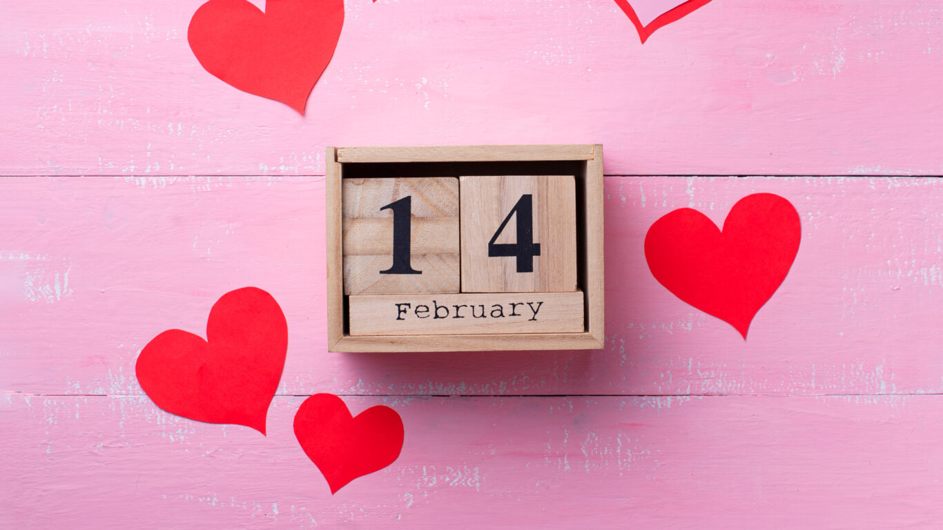 Valentine's Day romance at The Clarendon, with red hearts on a pink background, inviting cosy getaways and luxurious stays.