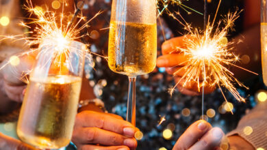 Guests celebrating with sparklers and champagne flutes at The Clarendon. Experience festive elegance and luxury dining.