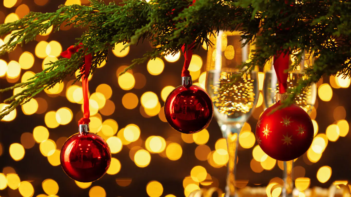 Festive decorations with red baubles and twinkling lights for a warm, luxurious holiday experience at The Clarendon Hotel.