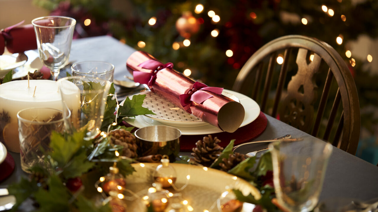 Festive dining at The Clarendon Hotel with elegant table setting, holiday decor, and warm lights, offering a cosy celebration.