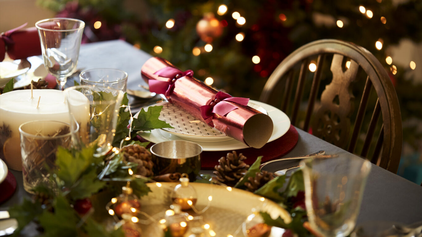 Festive dining at The Clarendon Hotel with elegant table setting, holiday decor, and warm lights, offering a cosy celebration.