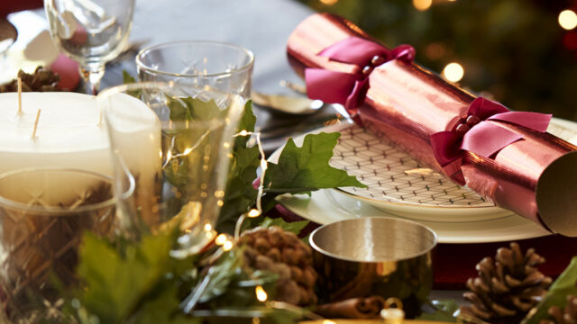 Festive table setting with elegant glassware, candles, and Christmas crackers at The Clarendon, perfect for holiday dining.