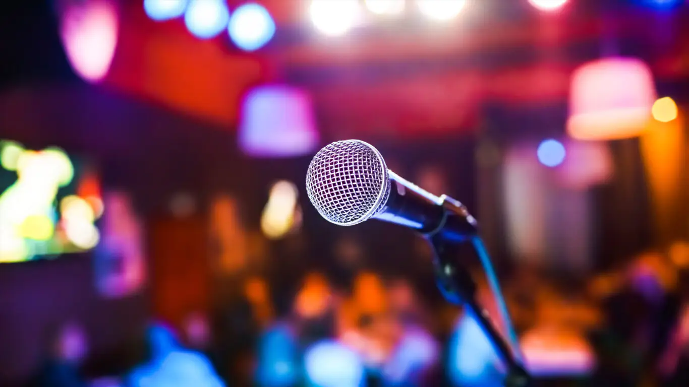 Microphone on stage with vibrant lighting at The Clarendon, perfect for lively events, live music, and unforgettable evenings.